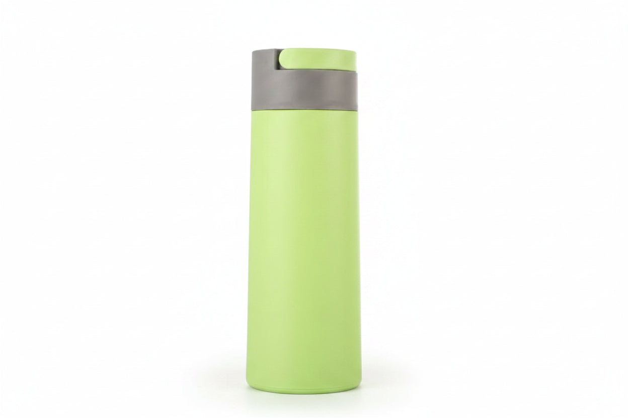 Sleek light blue 450ml double wall glass water bottle standing upright on an outdoor park bench